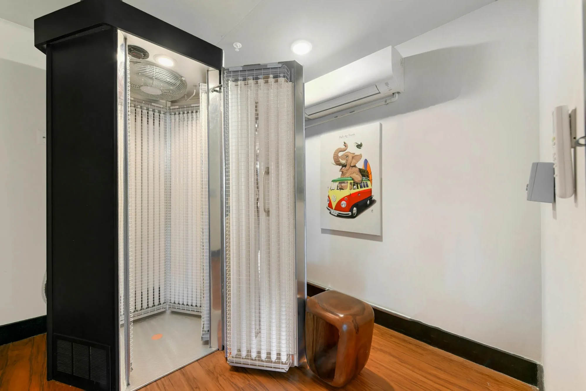 Indoor tanning booth with artwork nearby